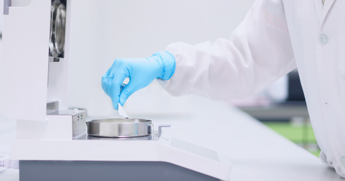 Scientist placing sample onto moisture balance