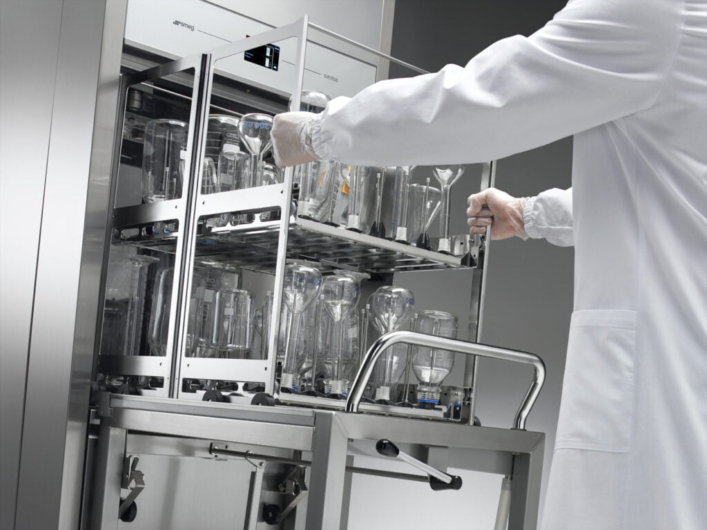Scientist removing clean glassware from SMEG labwasher